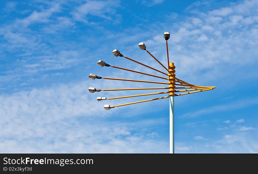 Stadium lights wthth cloudy blue sky on background