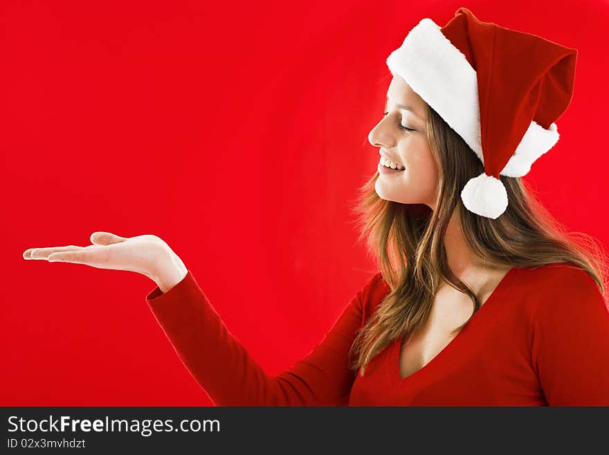 Smiling Santa Girl presenting your product, lots of copy-space. Smiling Santa Girl presenting your product, lots of copy-space