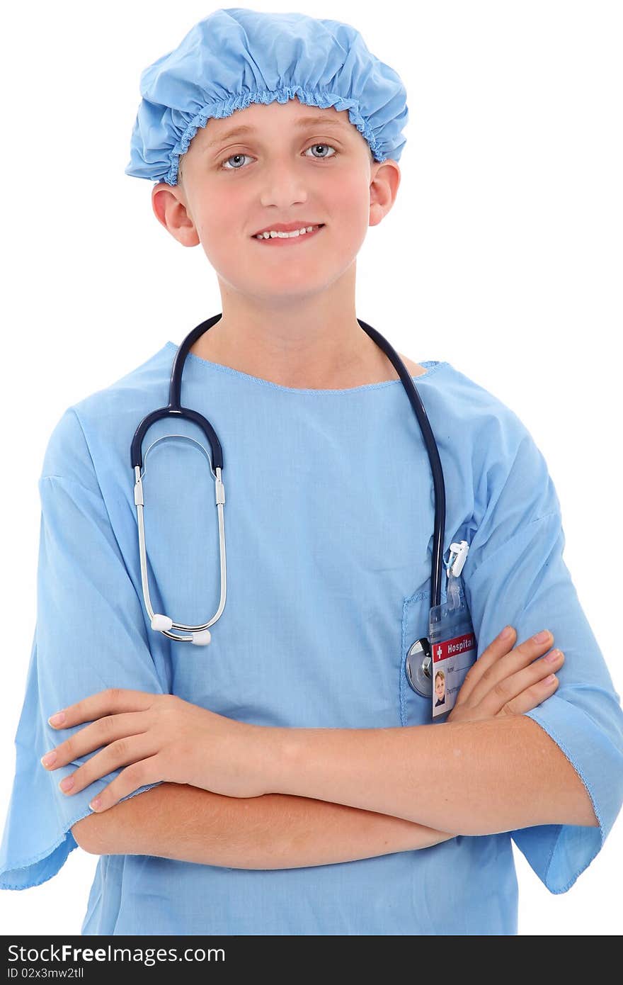 Adorable 12 year old boy dressed in surgical scrubs over white background. Adorable 12 year old boy dressed in surgical scrubs over white background.