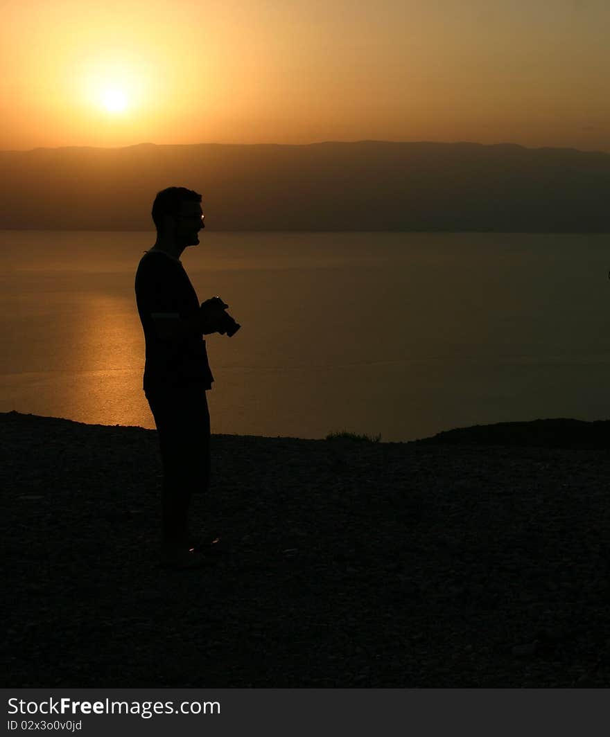 Photographer during sunrise over the dead sea in Israel