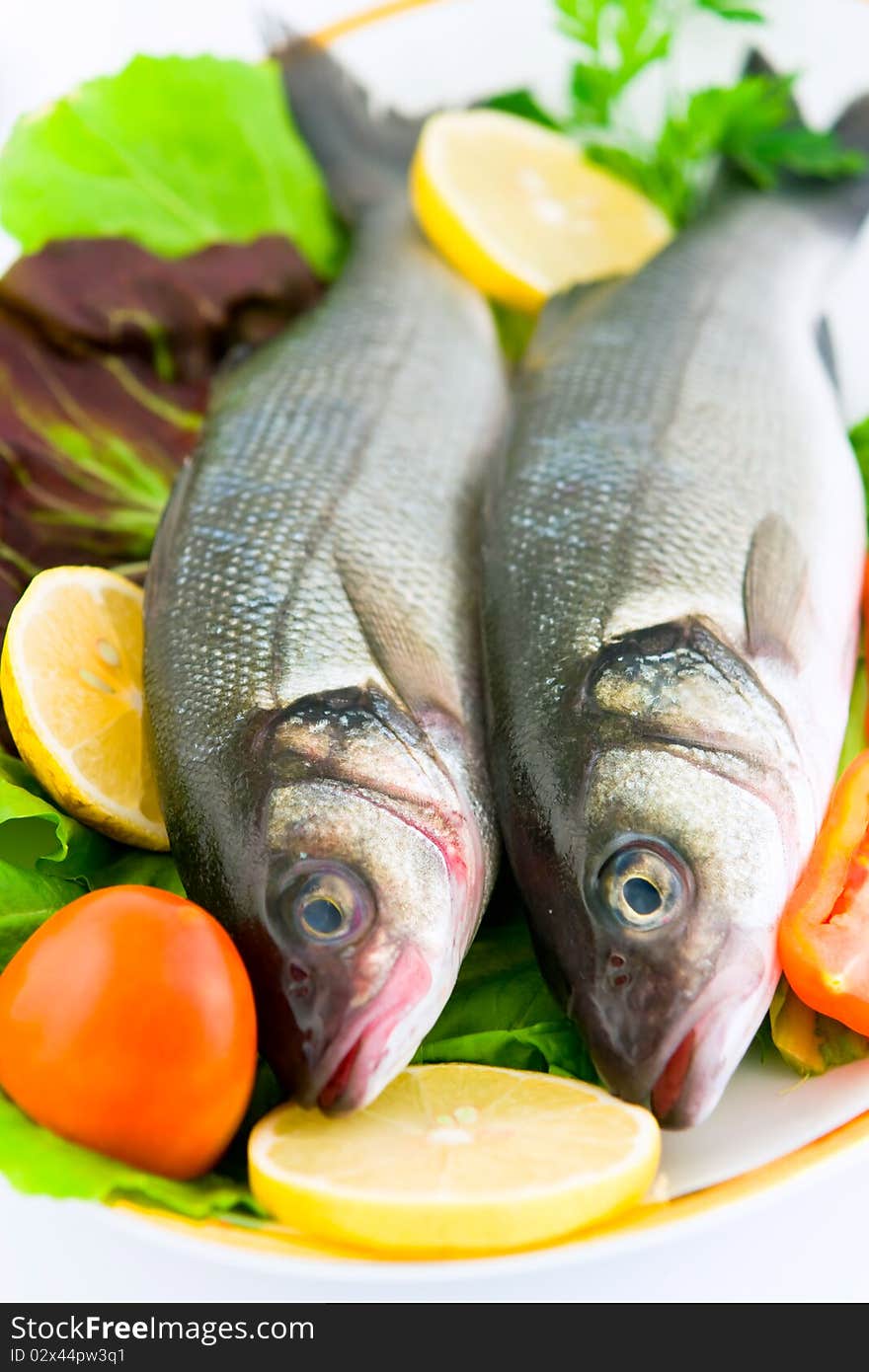 Fresh sea bass with vegetables, ready to cook