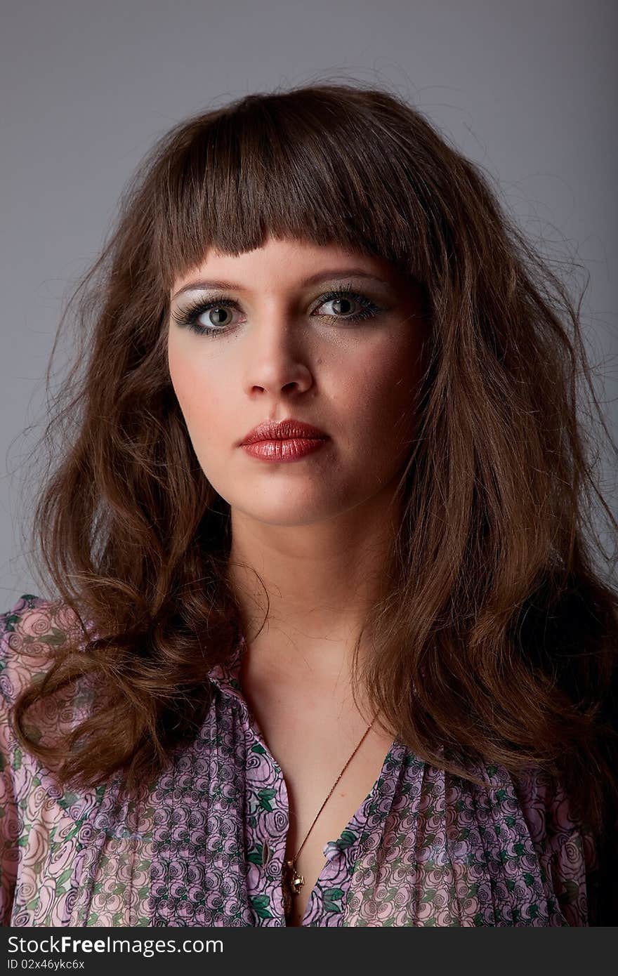 Fine portrait young woman over grey background