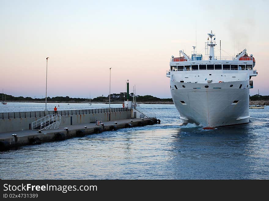 Ship maneuvering to moor at the port of Formentera. Ship maneuvering to moor at the port of Formentera.