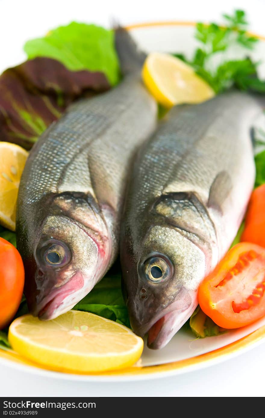 Fresh sea bass with vegetables, ready to cook