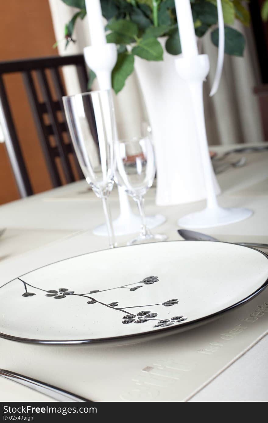 A dinner plate, knife, spoon and fork