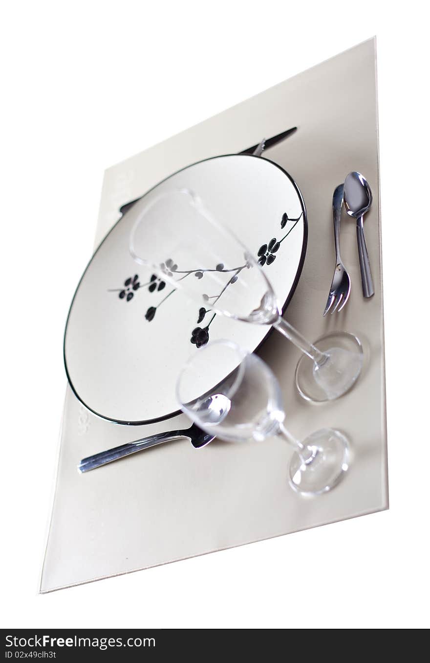 A dinner plate, knife, spoon and fork