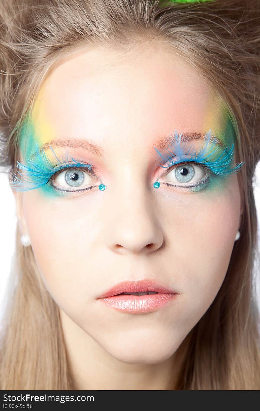 Beautiful woman with color makeup over white background. Beautiful woman with color makeup over white background