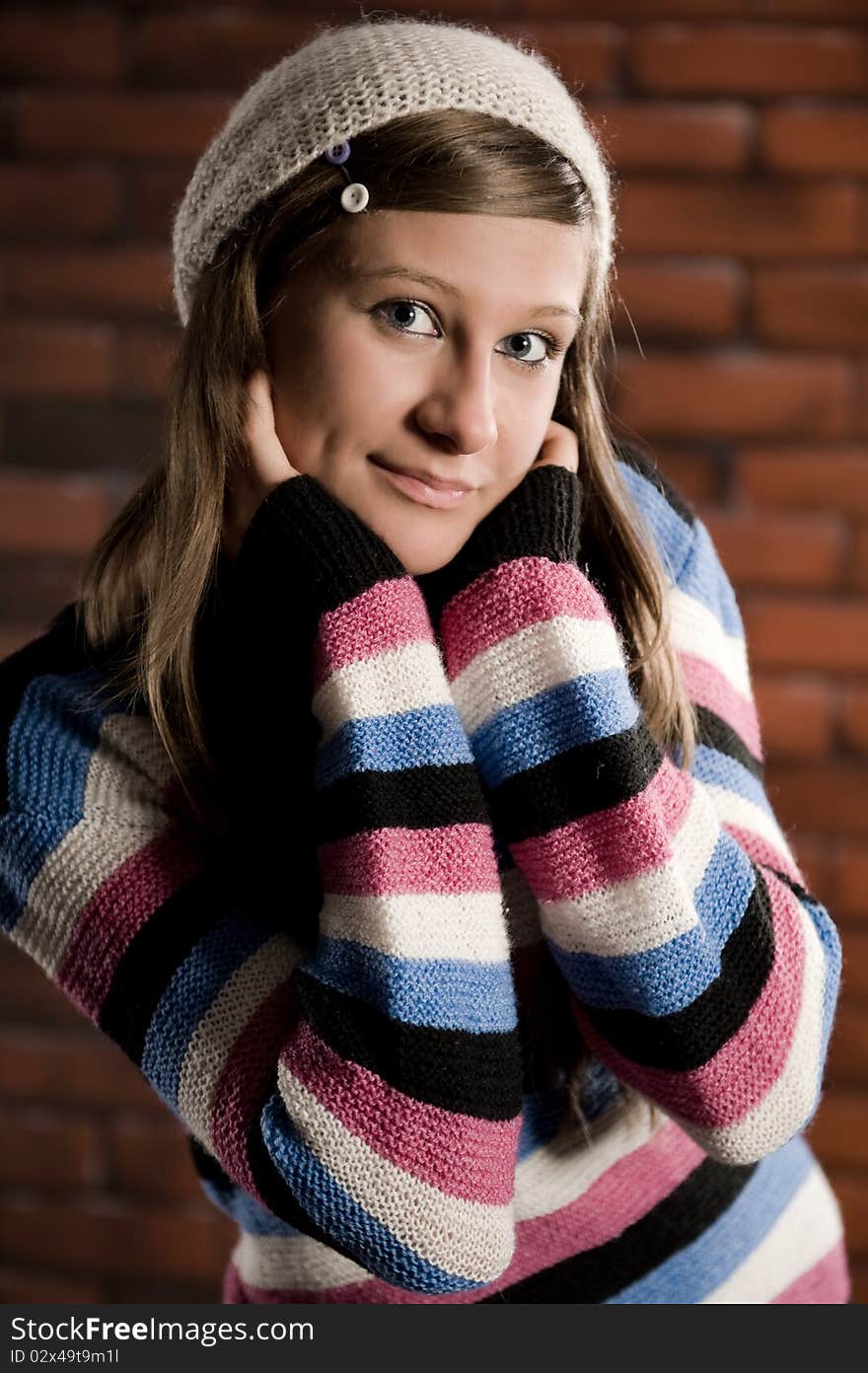 Cute girl making funny smile on the brick wall. Cute girl making funny smile on the brick wall