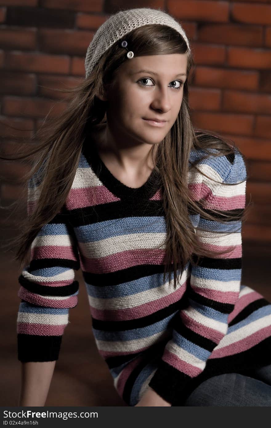 Cute girl making funny smile on the brick wall. Cute girl making funny smile on the brick wall