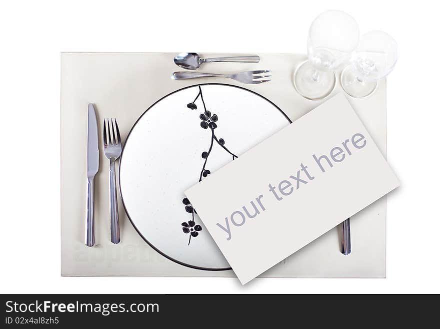 A dinner plate, knife, spoon and fork