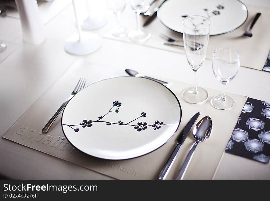 A dinner plate, knife, spoon and fork