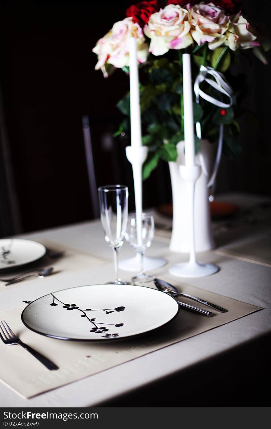 A dinner plate, knife, spoon and fork