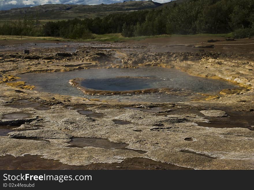 Icelands famous geyser Strokkur erupts. Nice shot at a sunny day against a cloudy sky. Icelands famous geyser Strokkur erupts. Nice shot at a sunny day against a cloudy sky.