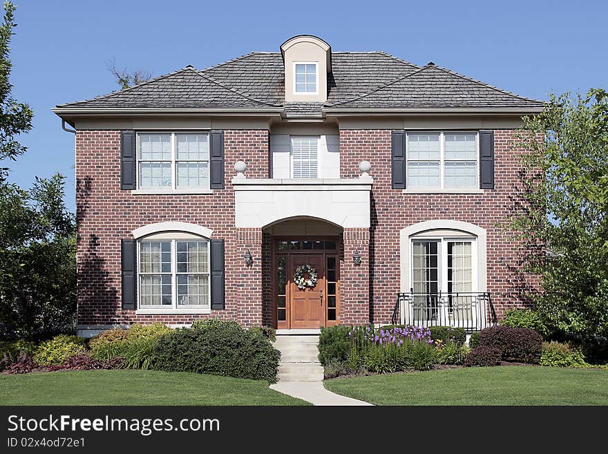 Brick home with front balcony