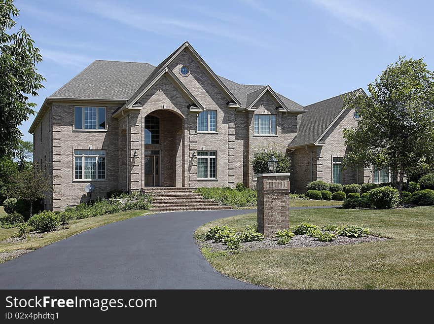 Large Brick Home With Arched Entry