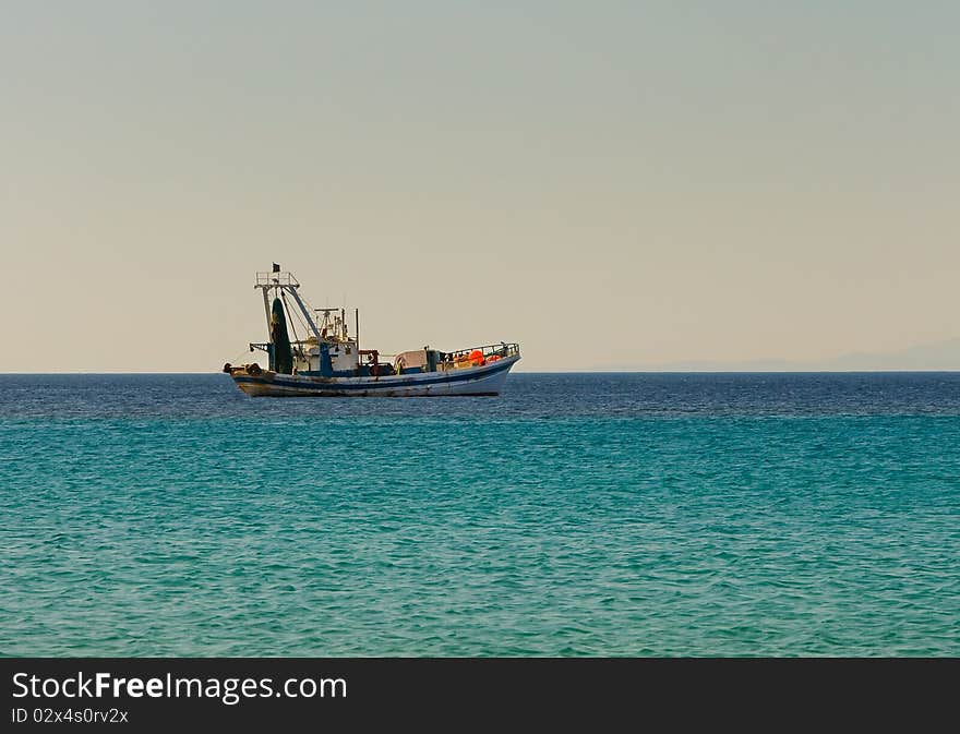 Fishing boat goes to fish in the evening