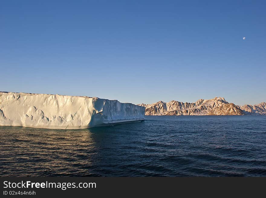 Iceberg, mountains and the moon