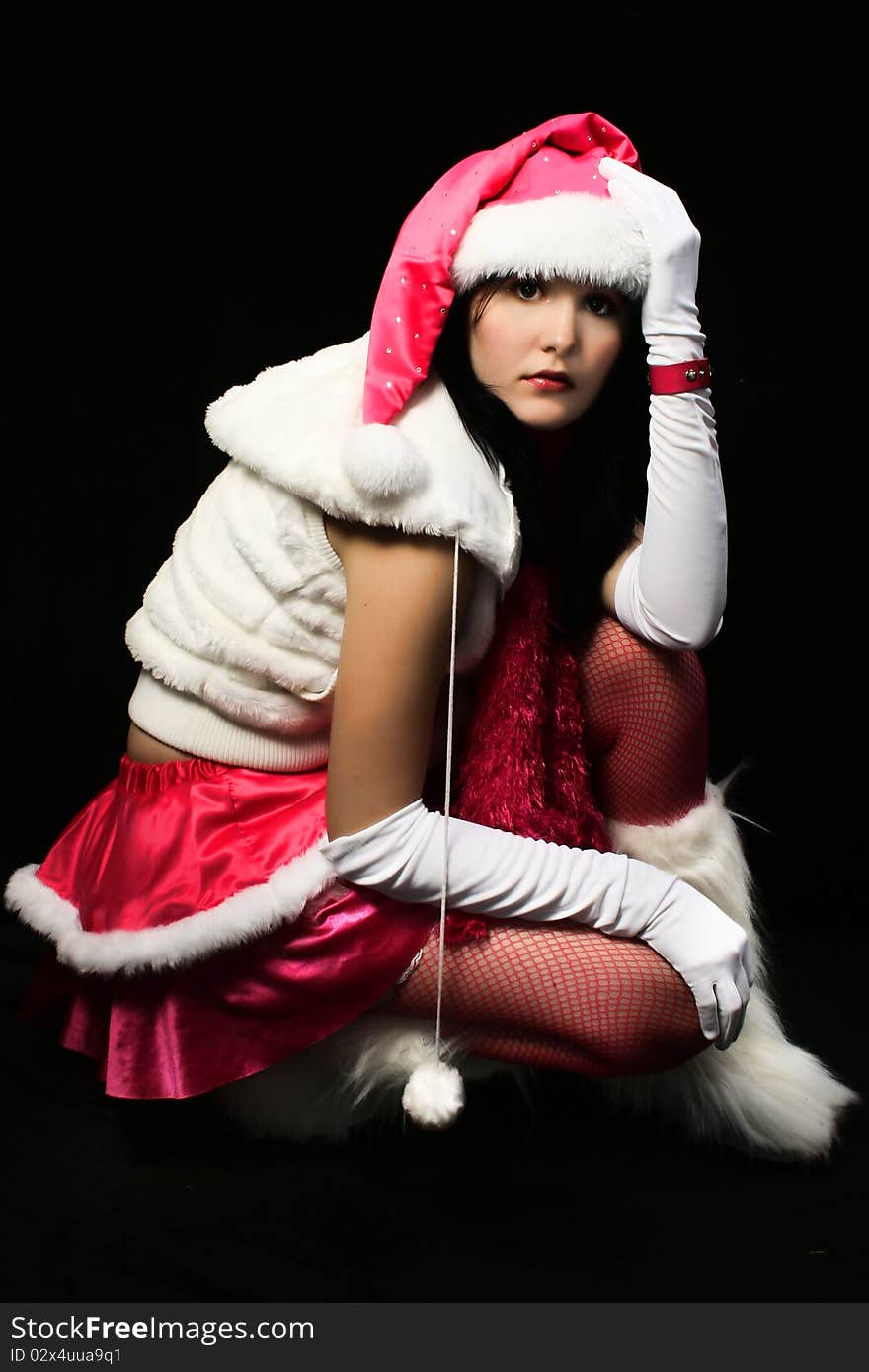 santa's helper in pink and white over dark background. santa's helper in pink and white over dark background.