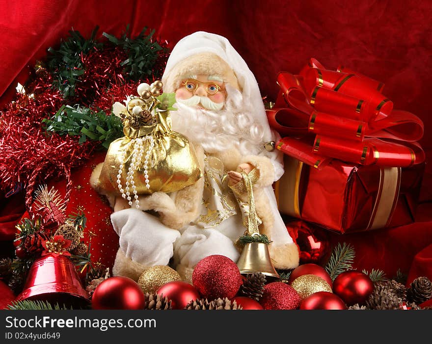 A toy Santa Claus on a background with red ribbons