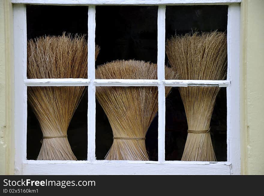 This is an image of three brooms throught a window at Shaker Village in Pleasant Hill Kentucky. It was also known as Shaker town. The Shakers were a small religious sect that began in the late 18th Century. There is a small number practicing their religion today. This is an image of three brooms throught a window at Shaker Village in Pleasant Hill Kentucky. It was also known as Shaker town. The Shakers were a small religious sect that began in the late 18th Century. There is a small number practicing their religion today.