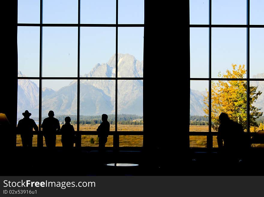 Group of people enjoying a view of the Teton mountain range in Wyoming. Group of people enjoying a view of the Teton mountain range in Wyoming.