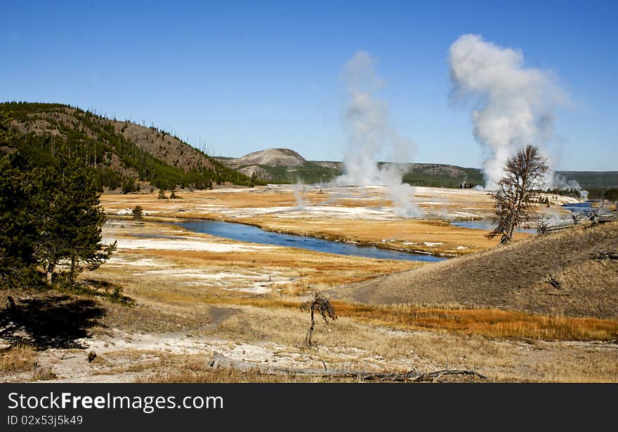 Valley in Yellowstone National Park with geysers and hot pools of water. Valley in Yellowstone National Park with geysers and hot pools of water.