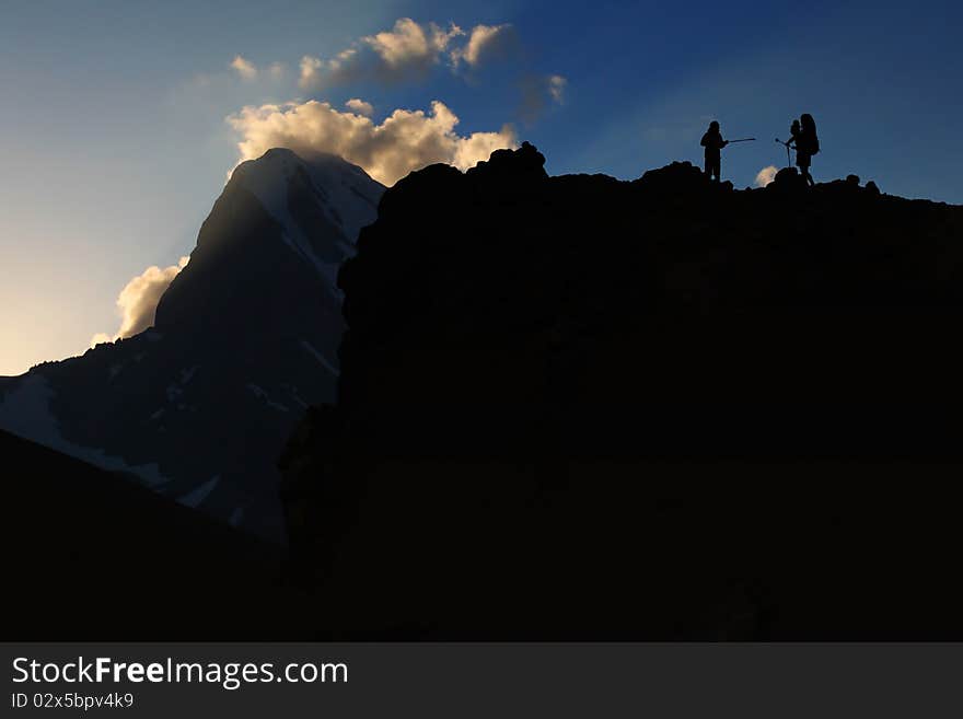 Mountain sport - silhouette of two climbers in high mountain pass. Mountain sport - silhouette of two climbers in high mountain pass