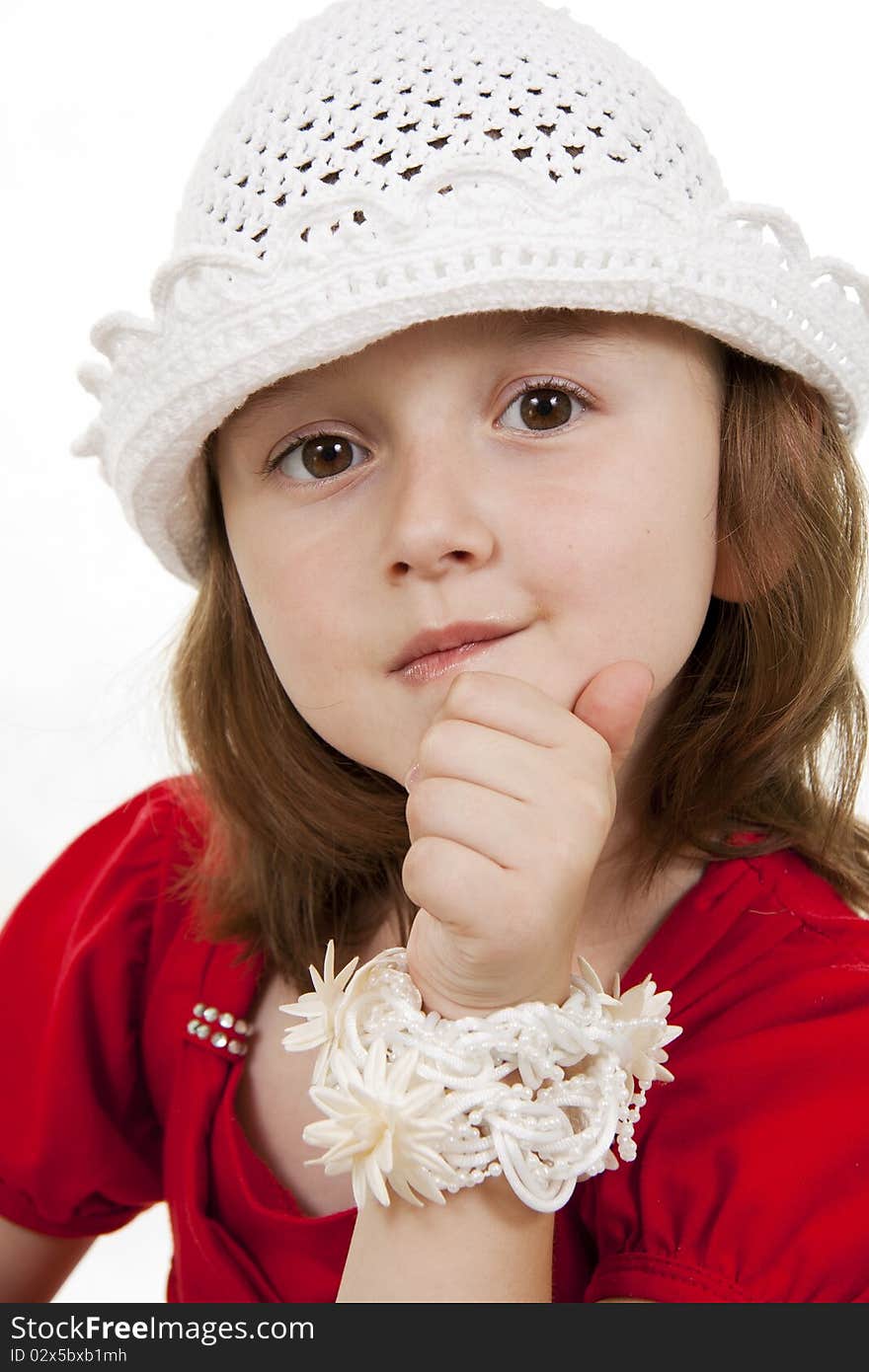 Portrait of the little girl in a white knitted cap. White background. Portrait of the little girl in a white knitted cap. White background.