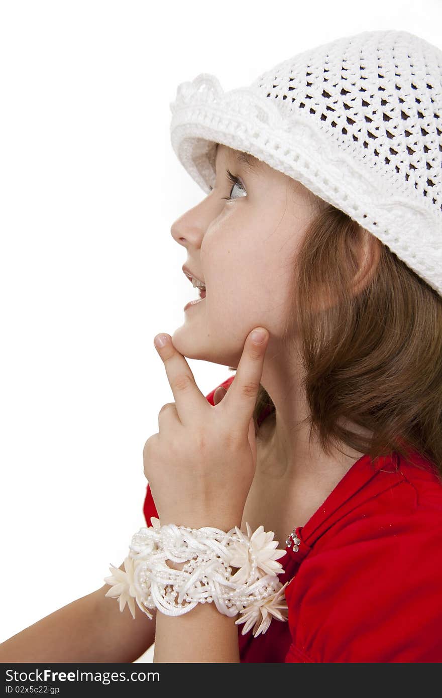 Portrait of the little girl in a white knitted cap. White background. Portrait of the little girl in a white knitted cap. White background.