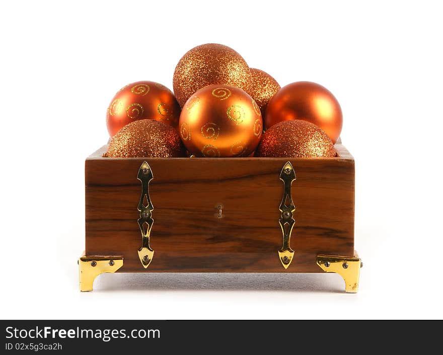 A chest full of different golden Christmals balls. The image is isolated on a white background. A chest full of different golden Christmals balls. The image is isolated on a white background.