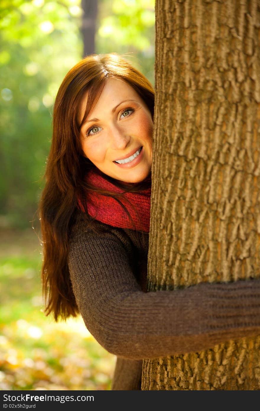 Park portrait woman with scarf embracing tree. Park portrait woman with scarf embracing tree