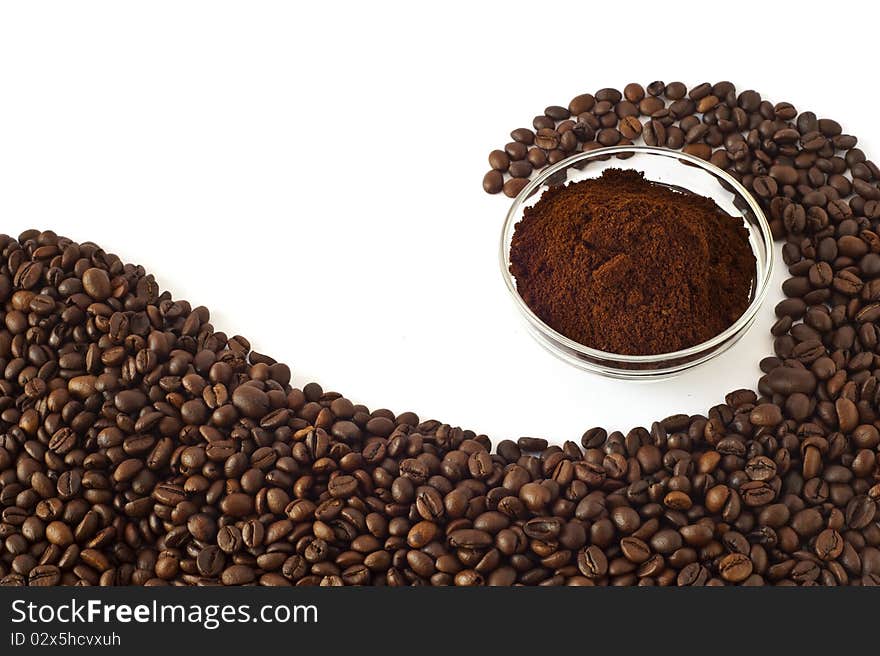 Coffee beans and ground coffee on a white background