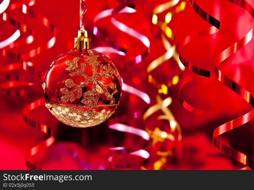 Christmas baubles and ribbons on red background. Studio shot. Christmas baubles and ribbons on red background. Studio shot