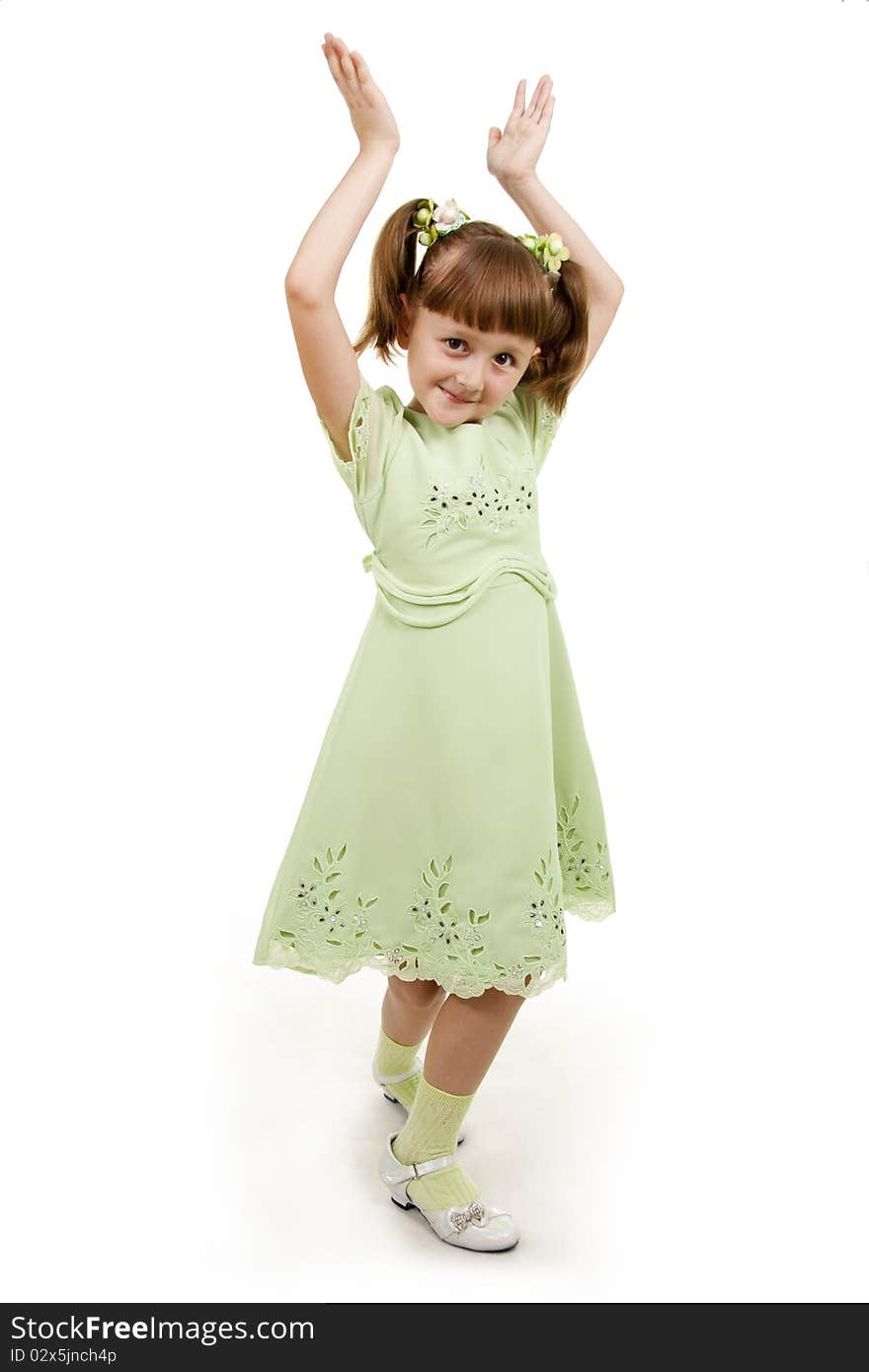 Llittle girl writes to a writing-book. A white background.