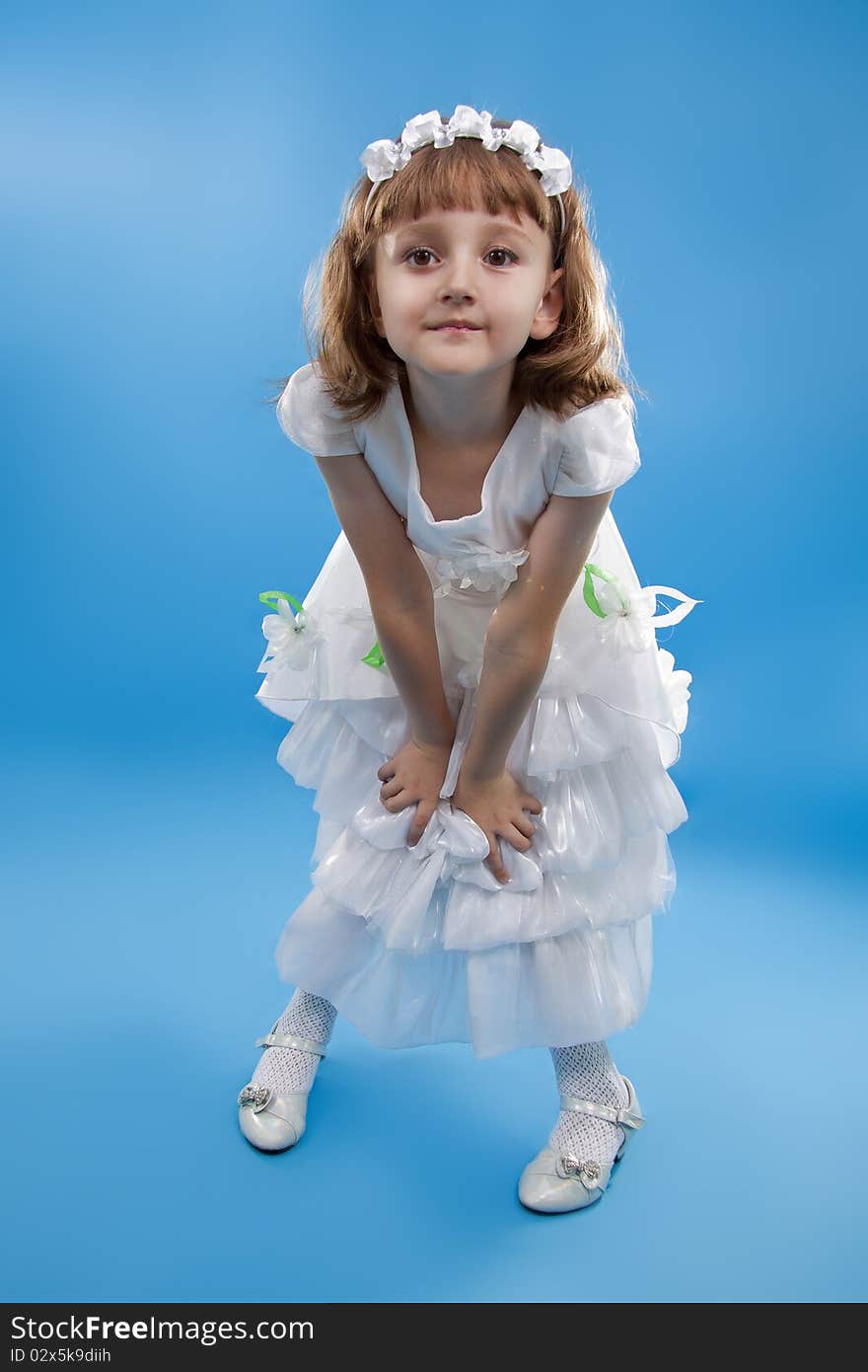 The girl the princess in a white dress. Blue background. The girl the princess in a white dress. Blue background.