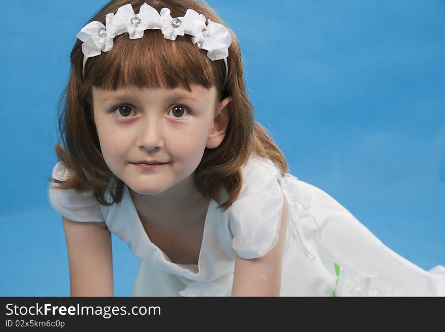 The girl the princess in a white dress. Blue background. The girl the princess in a white dress. Blue background.