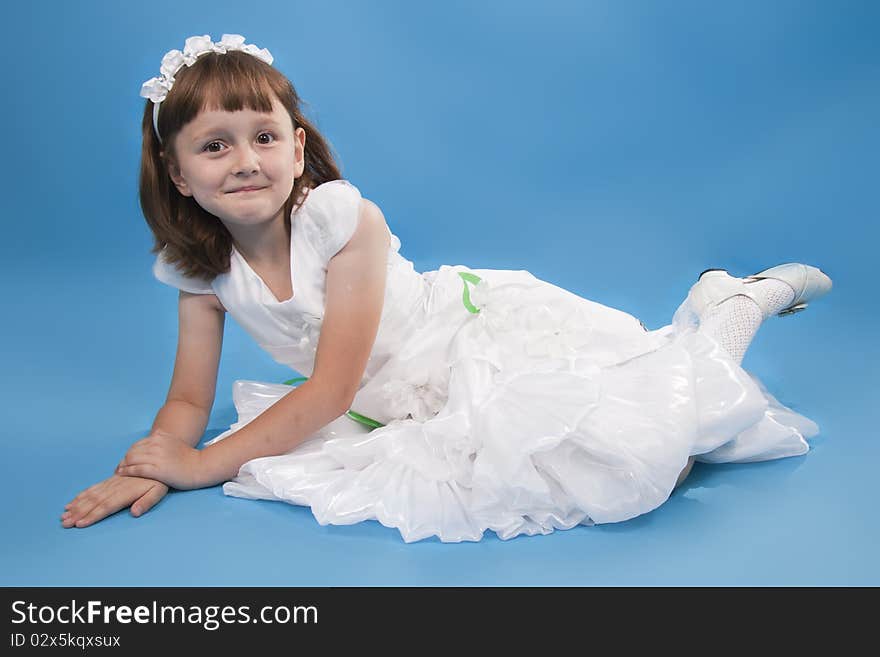 The girl the princess in a white dress. Blue background. The girl the princess in a white dress. Blue background.