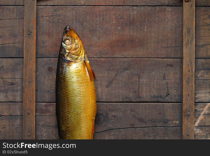 Closeup of fresh bloater lying on wooden background. Closeup of fresh bloater lying on wooden background