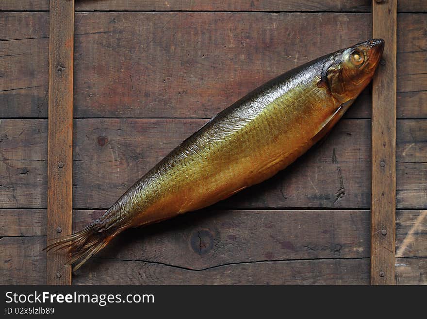 Closeup of fresh bloater lying on wooden background. Closeup of fresh bloater lying on wooden background