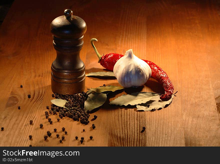 Still life with various spice near pepper mill on wooden background