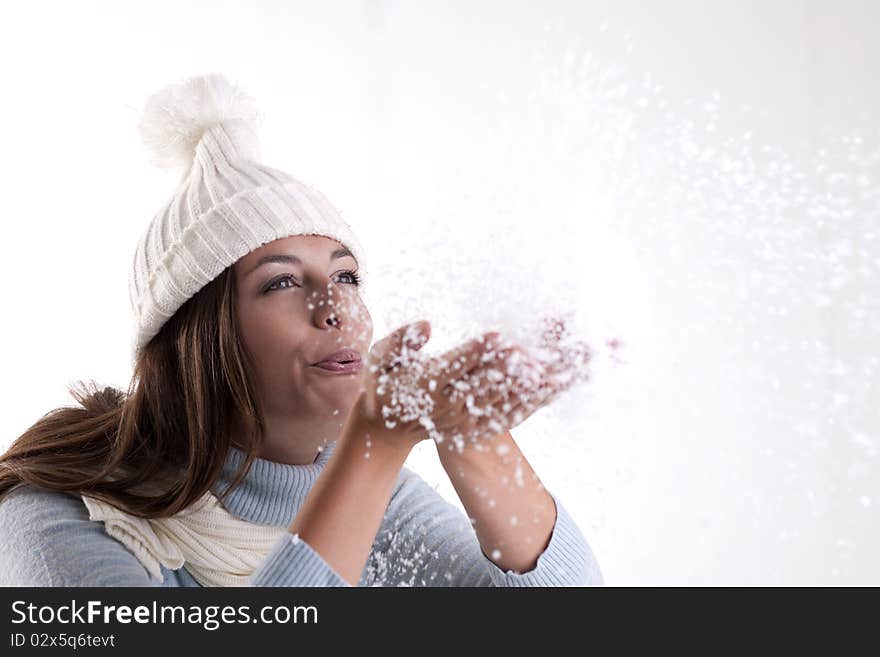 Beautiful woman blowing powder snow. Beautiful woman blowing powder snow