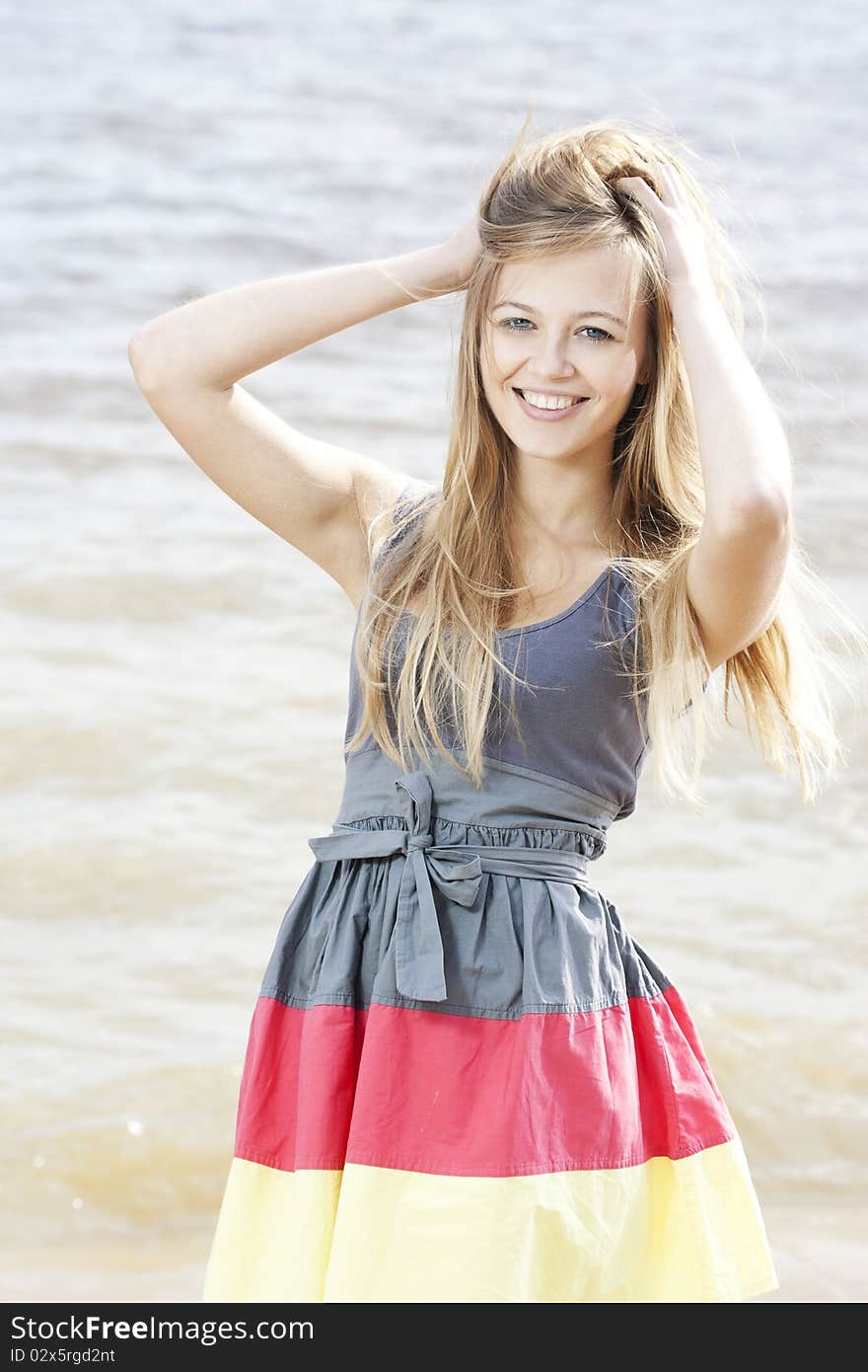 Portrait of a beautiful young woman at the sea