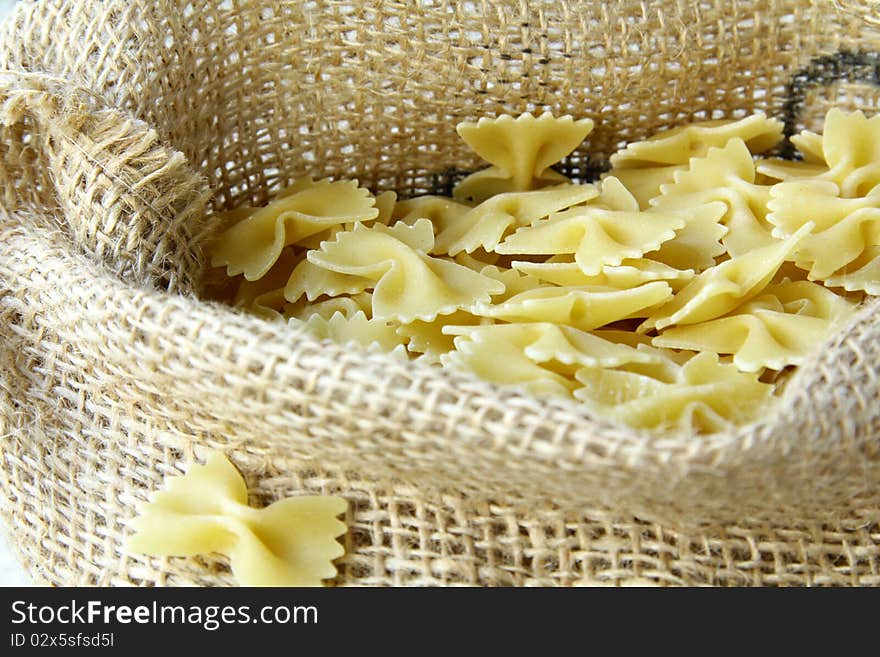 A lot of pasta in a bag on a wooden table