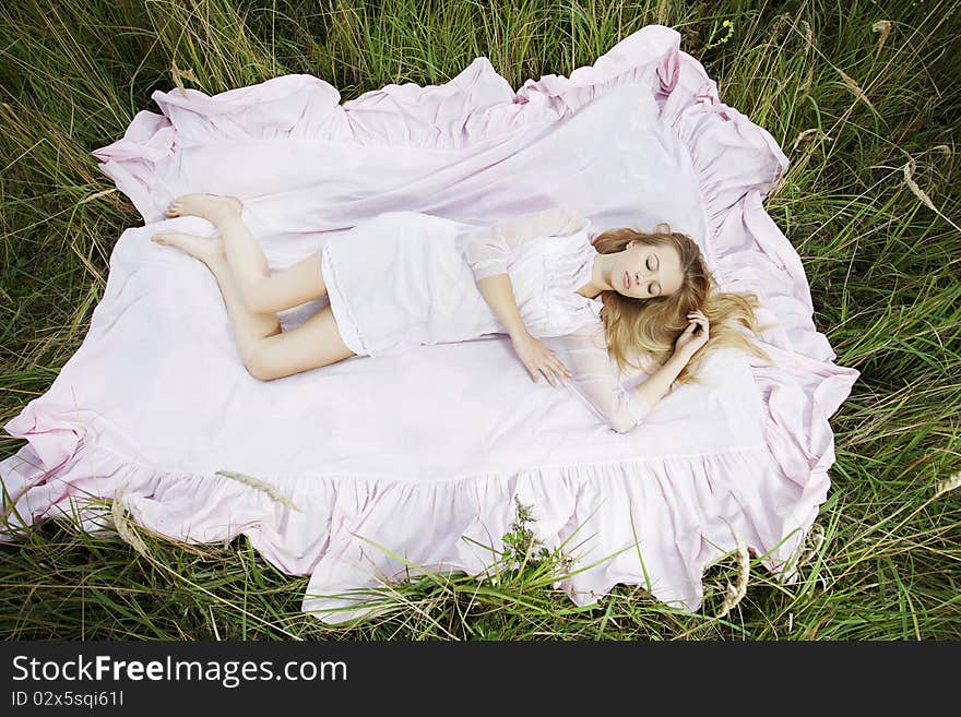 Woman lying on a sheet in field