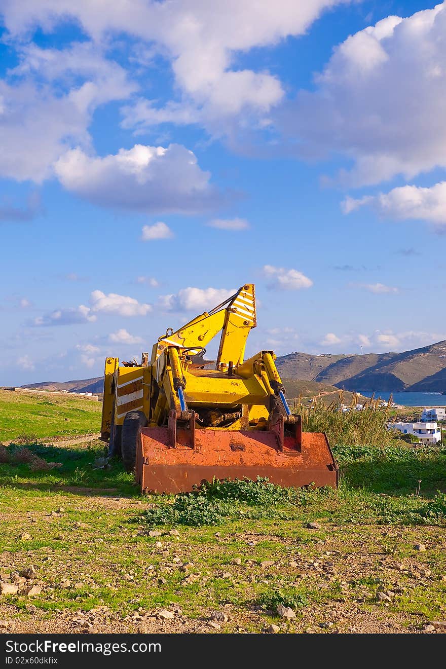 Yellow Bulldozer On The Grass In The Countryside