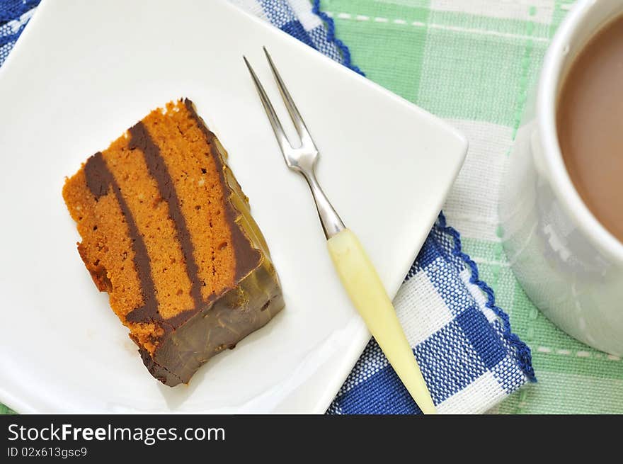 Delicious layered cake with hot beverage for snack or dessert.