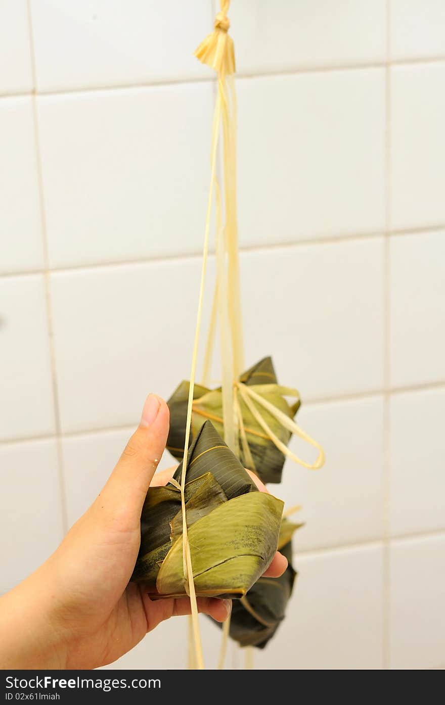 Asian glutinous dumplings wrapped in bamboo leaf. For food and beverage, culture and creative cuisine concepts. Asian glutinous dumplings wrapped in bamboo leaf. For food and beverage, culture and creative cuisine concepts.