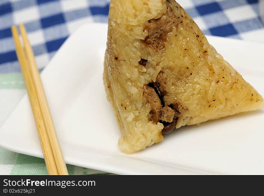 Delicious glutinous rice dumpling with chopsticks. Delicious glutinous rice dumpling with chopsticks.