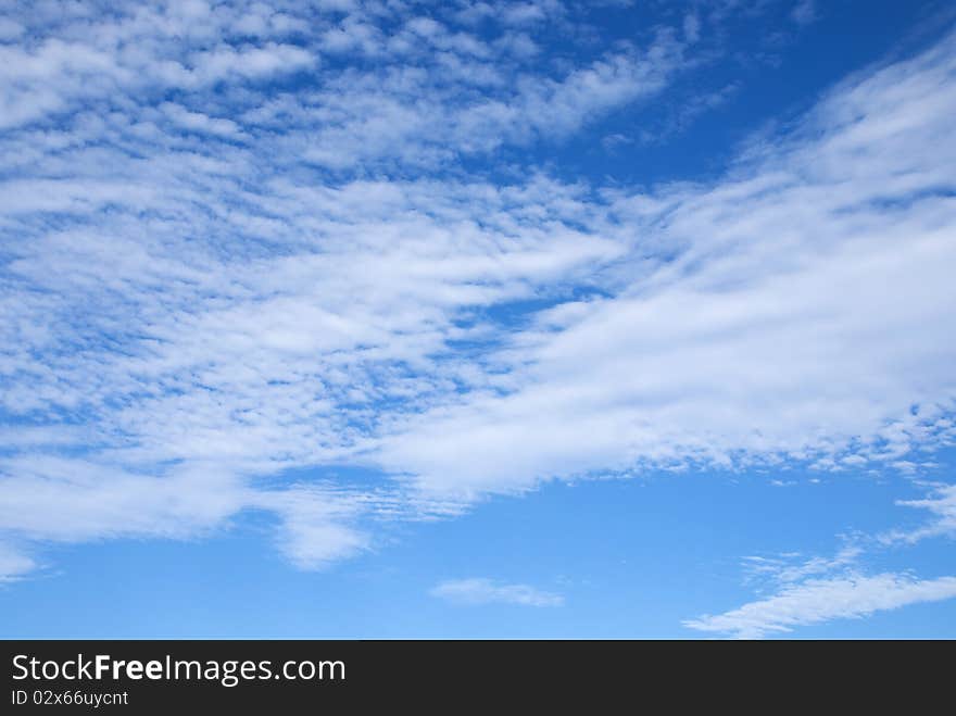 White clouds on blue sky to the island of La Maddalena in Sardinia. White clouds on blue sky to the island of La Maddalena in Sardinia