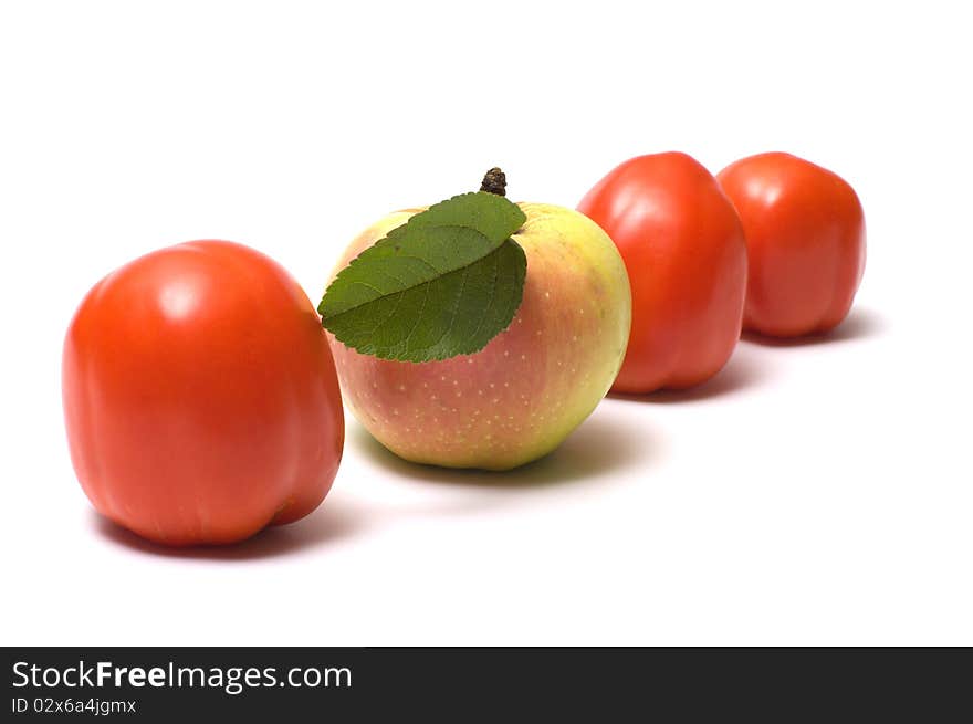 Three red tomato and apple on a white background. Three red tomato and apple on a white background.